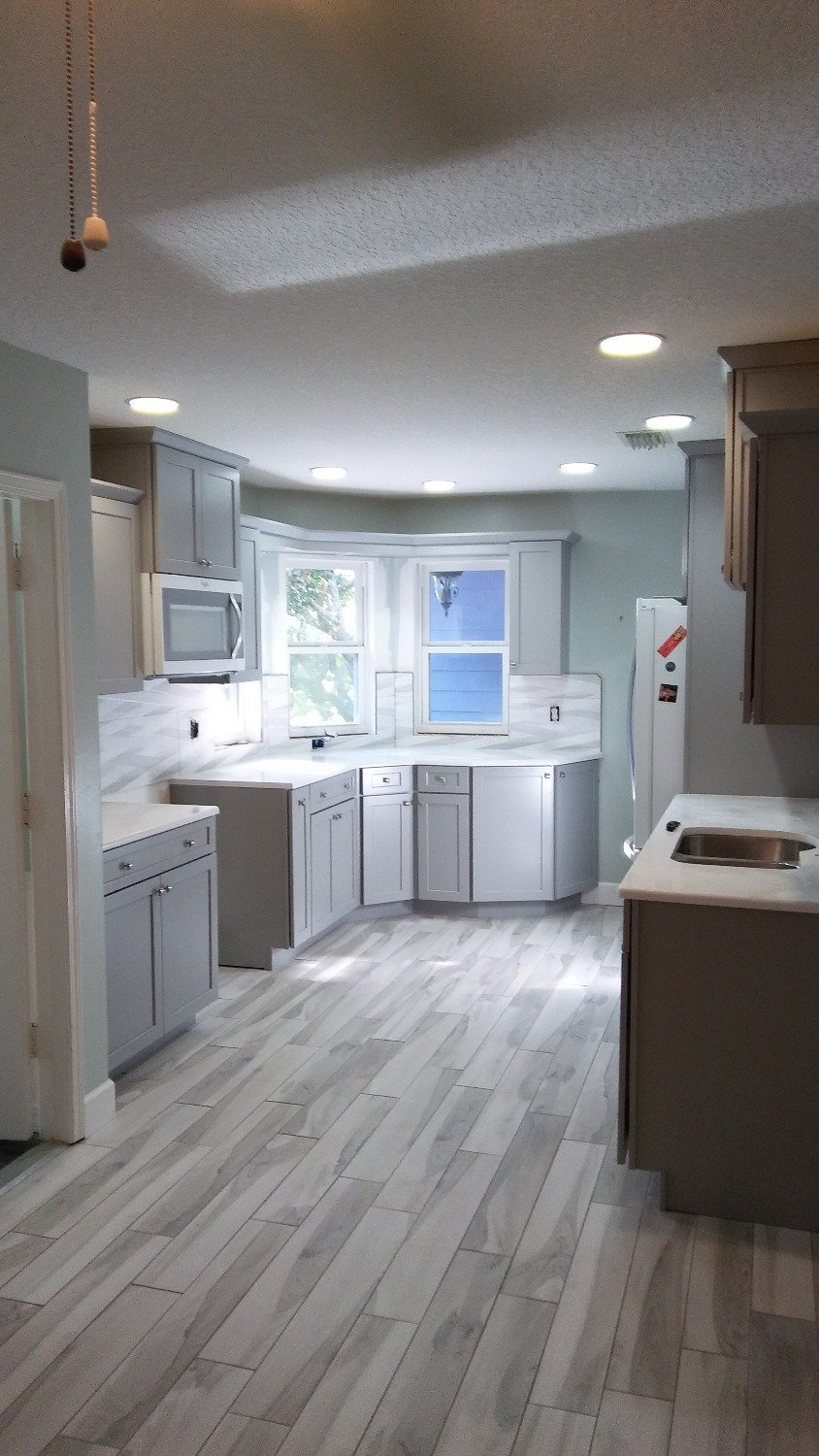 Kitchen with wood-look plank tile flooring